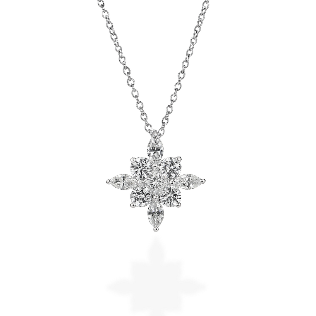 Diamond starburst pendant on a chain against a white background