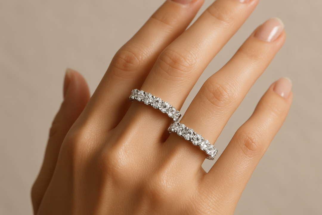 A hand with 2 diamond eternity rings on it